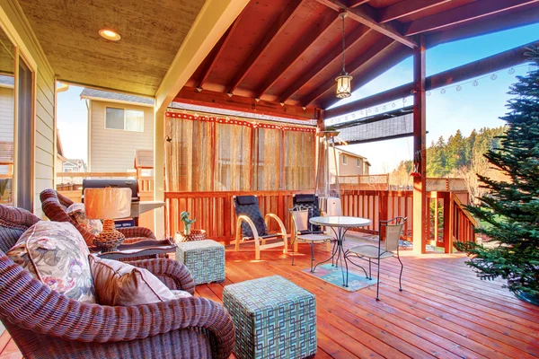 Exterior covered patio with furniture.