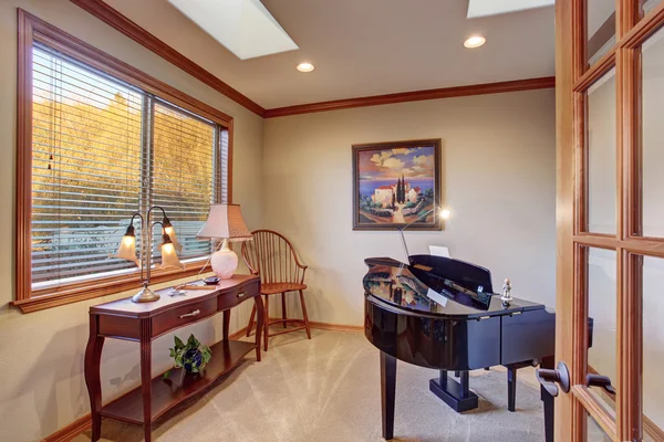 Piano room with antique furniture and carpet floor