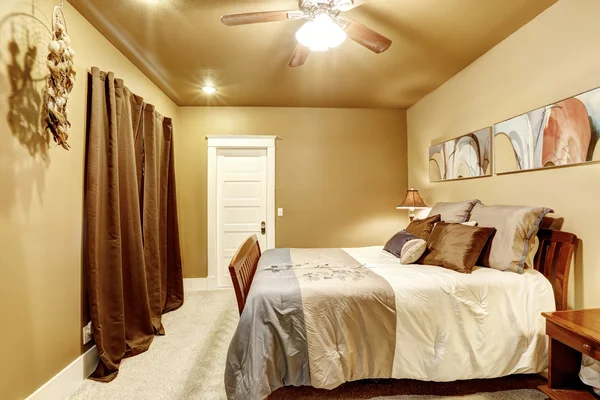 Nice bedroom with mocha interior paint and beige carpet.