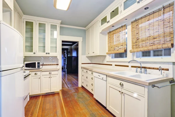 White empty simple old kitchen room with hardwood flooring