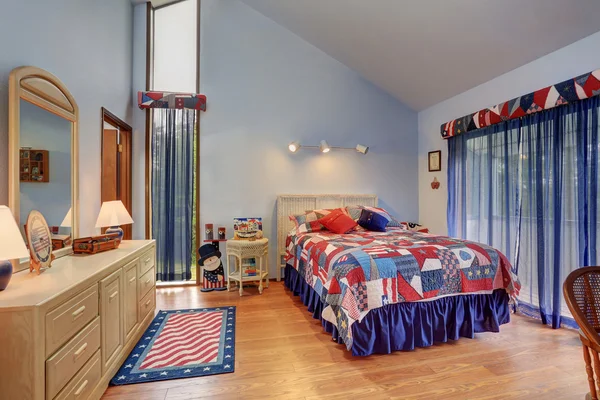 Red and blue interior of vaulted ceiling bedroom in American style.