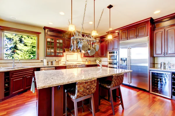 Luxury modern kitchen room with mahogany storage combination .