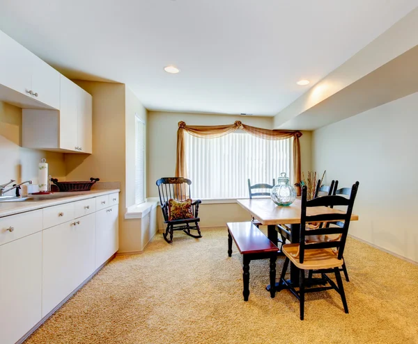 Old simple white and wood kitchen interior with carpet floor