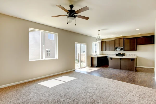 Small yet practical kitchen with brown cabinets and hardwood flooring.