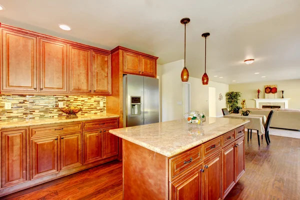 Practical kitchen with storage combination and steel fridge.