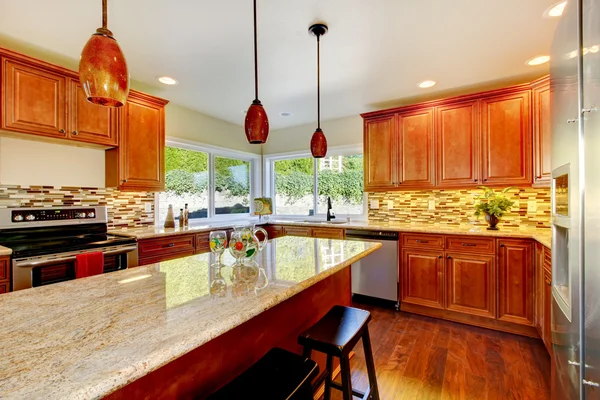 Practical kitchen with storage combination and granite tops.