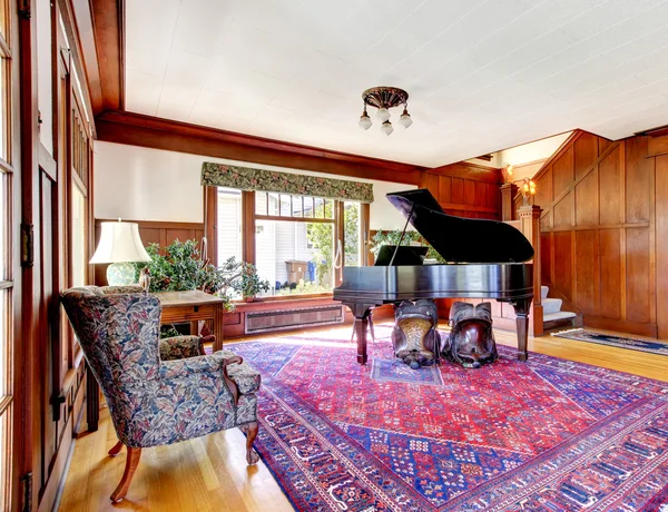 Bright living room with wooden panel trim walls and grand piano