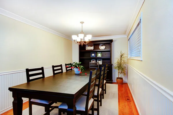 Gorgeous black dinner table chair set in dining room.