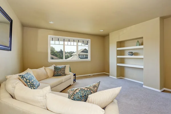 Cozy sitting room with large beige corner sofa set.