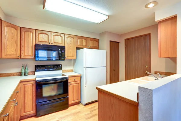 Wooden kitchen interior with white built-in fridge