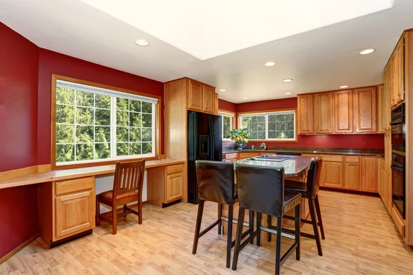 Kitchen room interior with red walls, granite counter top and bar stand.