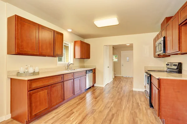 Open floor plan kitchen room interior with wooden cabinets