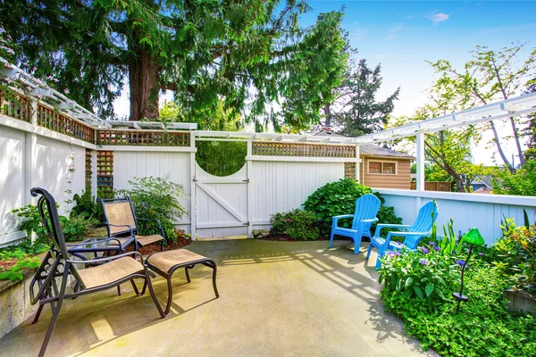 Yellow house backyard area with patio