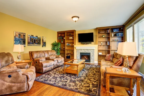 Typical American living room design with fireplace and sofa set.