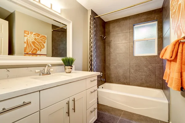 Bathroom interior with white vanity, big mirror and tile floor.