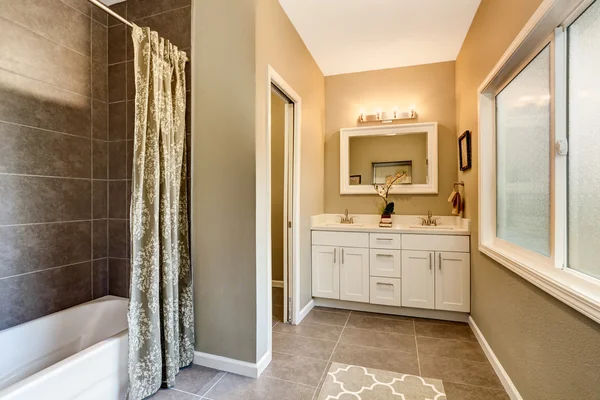 Bathroom interior with nice vanity and tile trim.