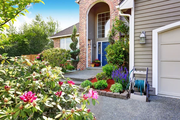 Luxury house with brick and siding trim, concrete floor porch.