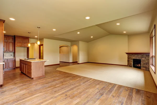 Open floor plan. Empty living room with carpet floor.