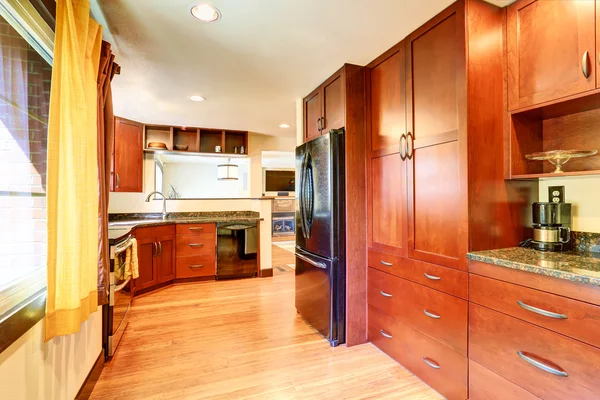 Kitchen interior with black appliances and granite tops