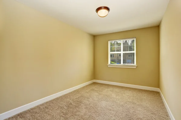 Small yellow empty room interior with window