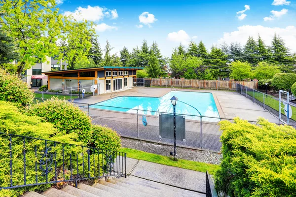 Residential building with swimming pool and patio area.