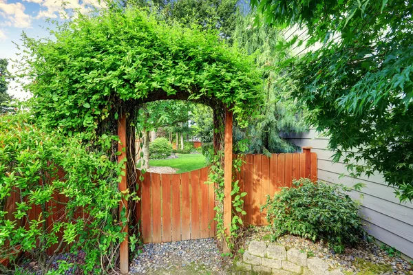Nice wooden gate with well kept garden.