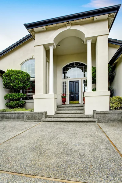 Luxury house entry way exterior with concrete floor porch.