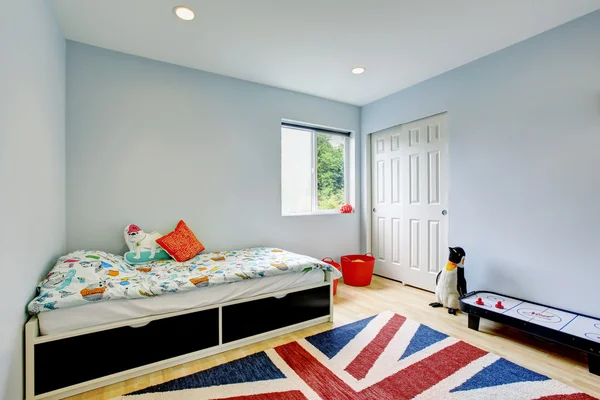 Modern kids bedroom interior in blue tones, hardwood floor and walk-in closet.