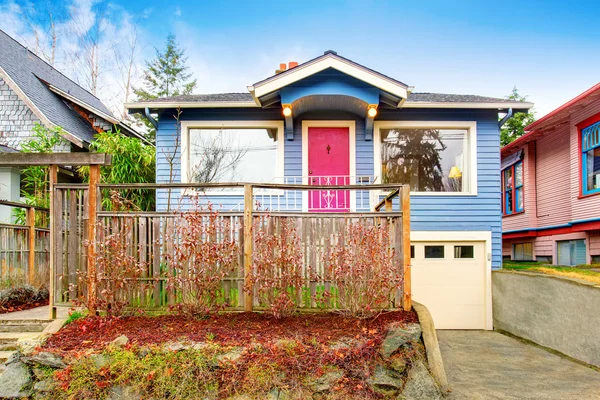 Classic American house exterior with blue trim and red front door