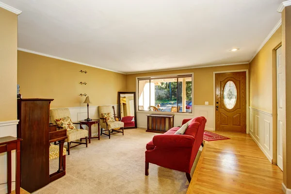 Living room interior with vintage furniture, antique piano. Connected to dining area.