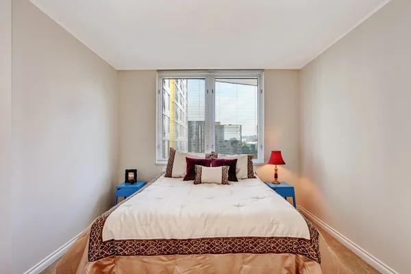 Simple beige bedroom interior with brown and creamy tones bed.