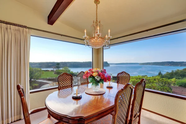 Dining room with carved wood table set and water view