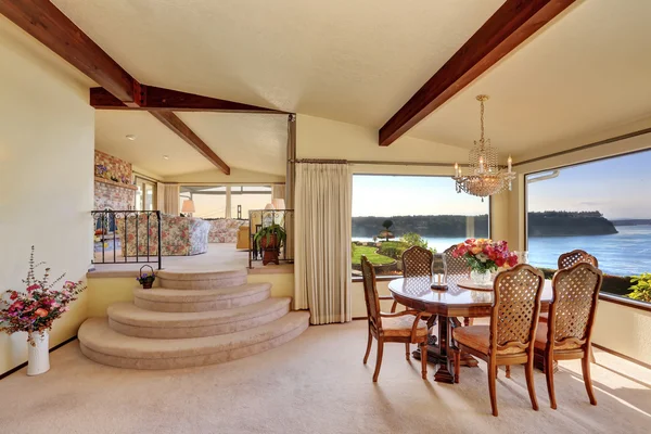 Dining room with carved wood table set and water view