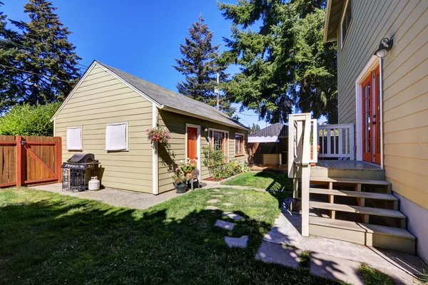 Backyard view of craftsman house with a shed