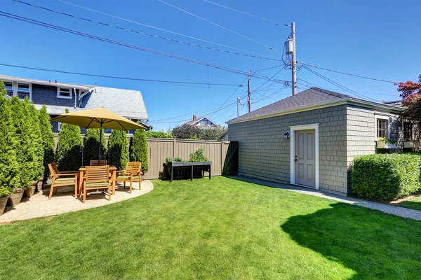 Nice green shed in the backyard of American craftsman house.