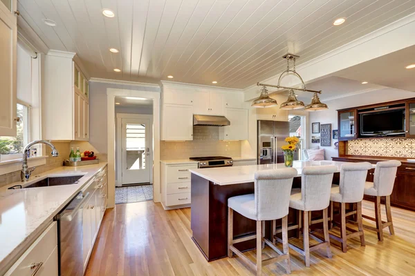 White interior of kitchen room with large kitchen island.
