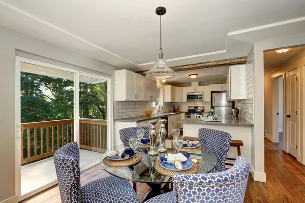 Dining area with blue chairs and table setting
