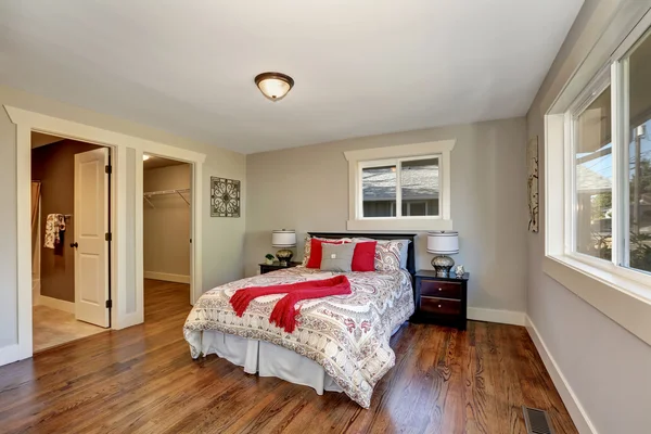 View of tidy bedroom with hardwood floor