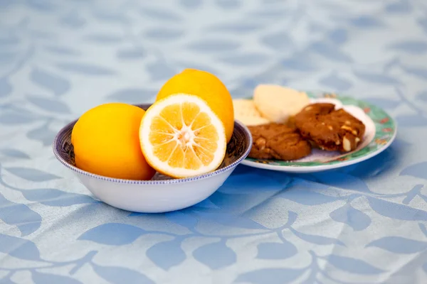 Table served with oranges and  cookies for a snack