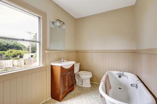 Traditional bathroom interior with tube and tile floor