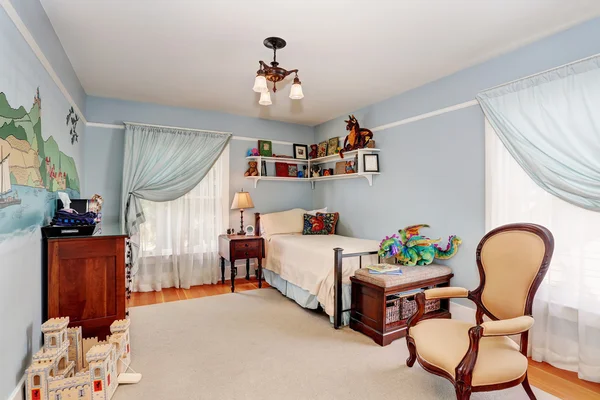 Kids bedroom interior in blue tones with cherry wooden furniture and nice curtains.