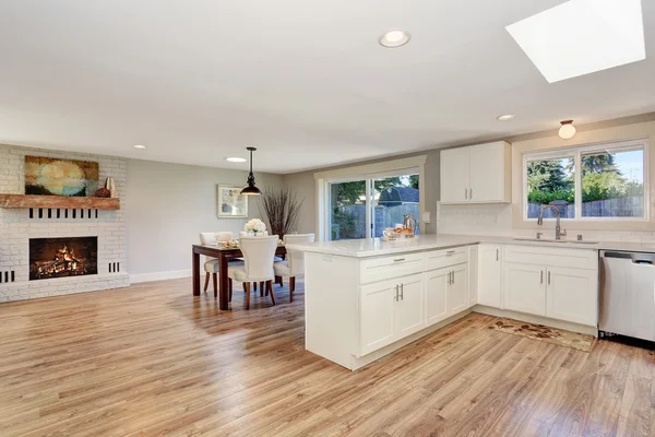 Modern kitchen room interior in white tones with hardwood floor.