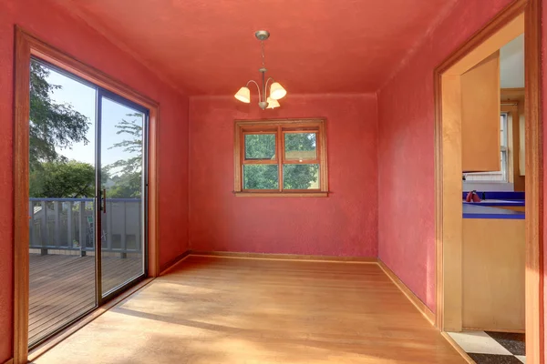 Hallway interior in red tones with hardwood floor. The room has exit to balcony.