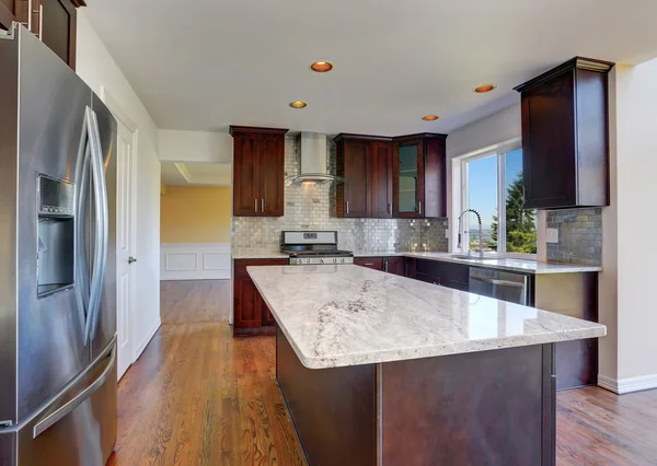 Kitchen room interior with deep brown cabinets with granite counter top