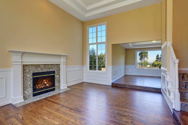 Open floor plan living room interior with hardwood floor and fireplace