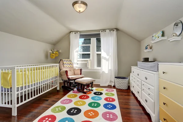Kids bedroom with nice crib and colorful rug