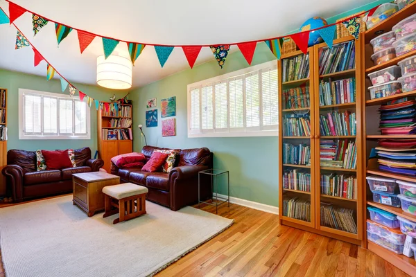 Room with bookcase decorated with colorful flags