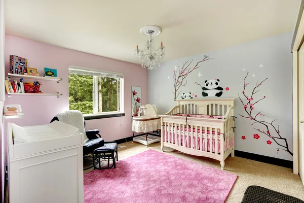 Light pink and blue nursery room with crib