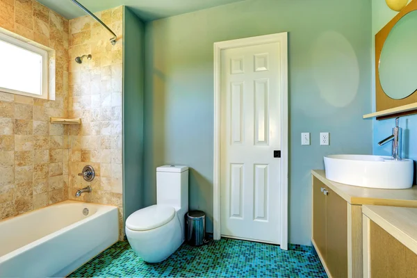 Bathroom interior in light blue with tile wall trim