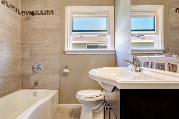 Empty bathroom interior with tile wall trim in soft beige color